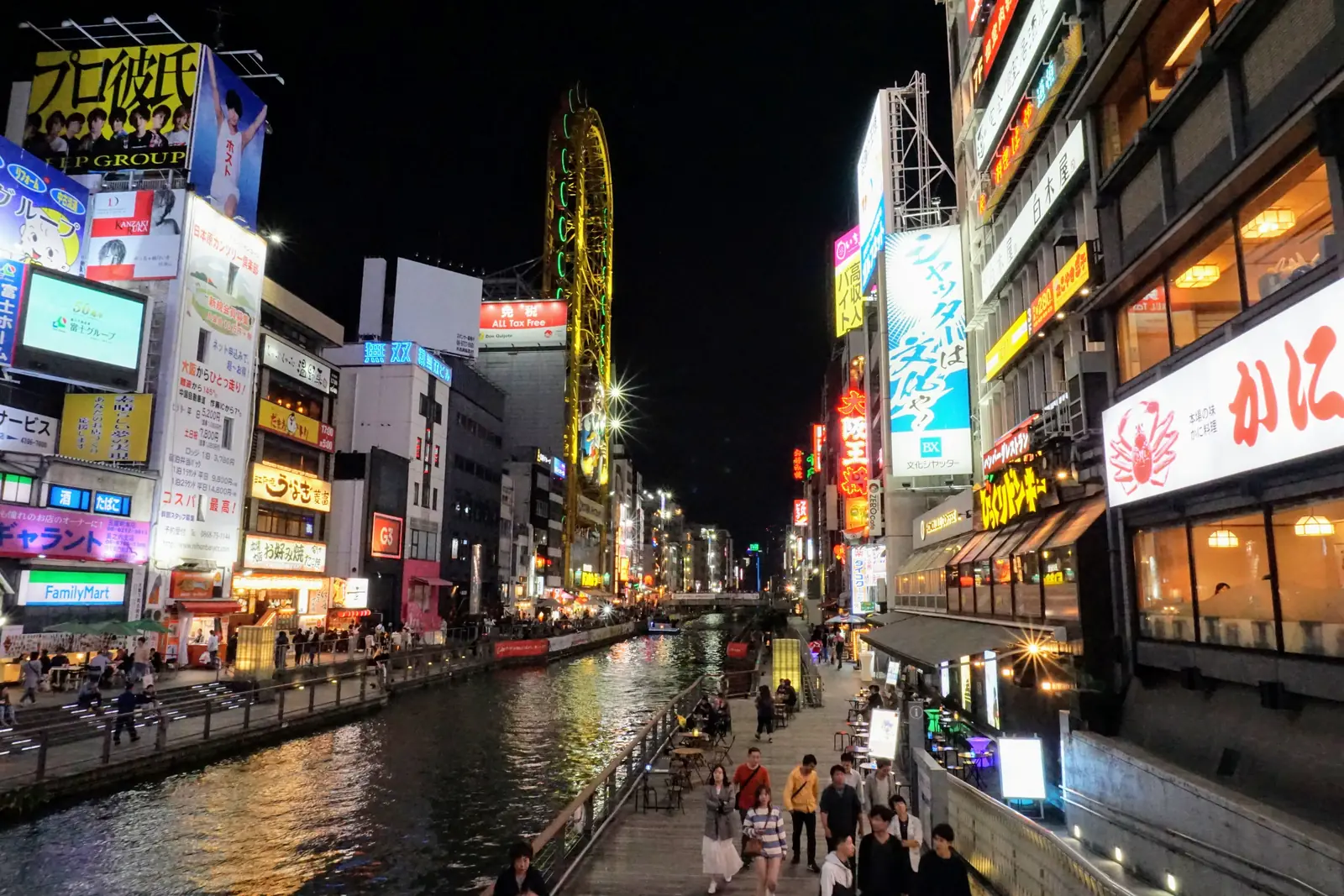 Neon signs reflected in the Dotonbori canal in Osaka at night