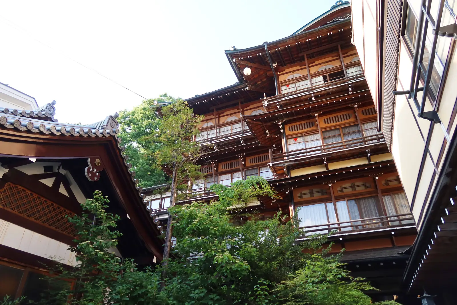 A traditional wooden ryokan with wide balconies in a Japanese hot spring town