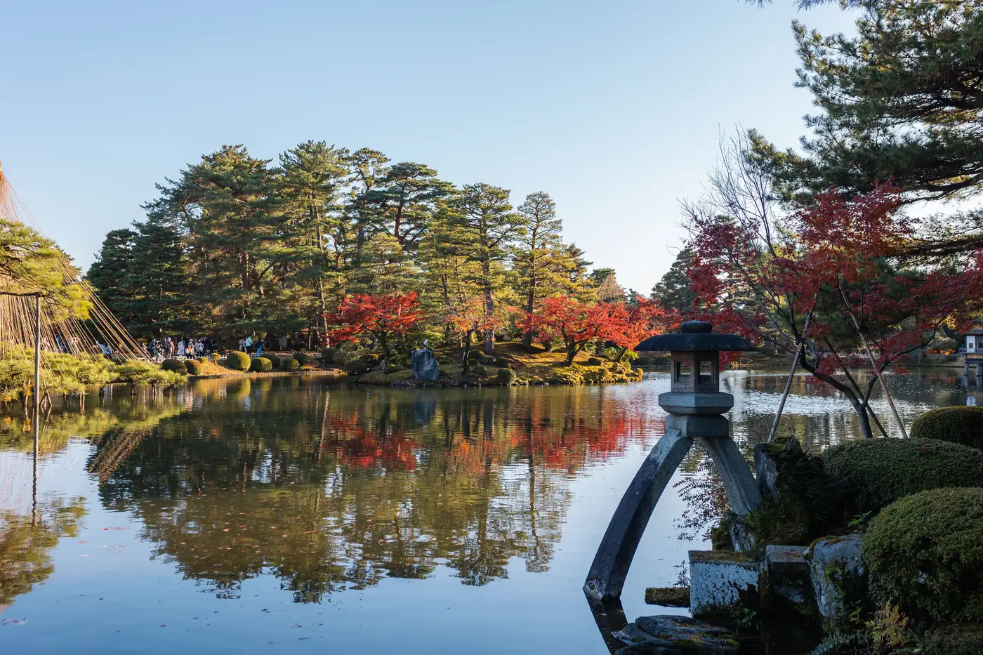 A stone lantern beside the pond at Kenroku-en garden in Kanazawa in autumn