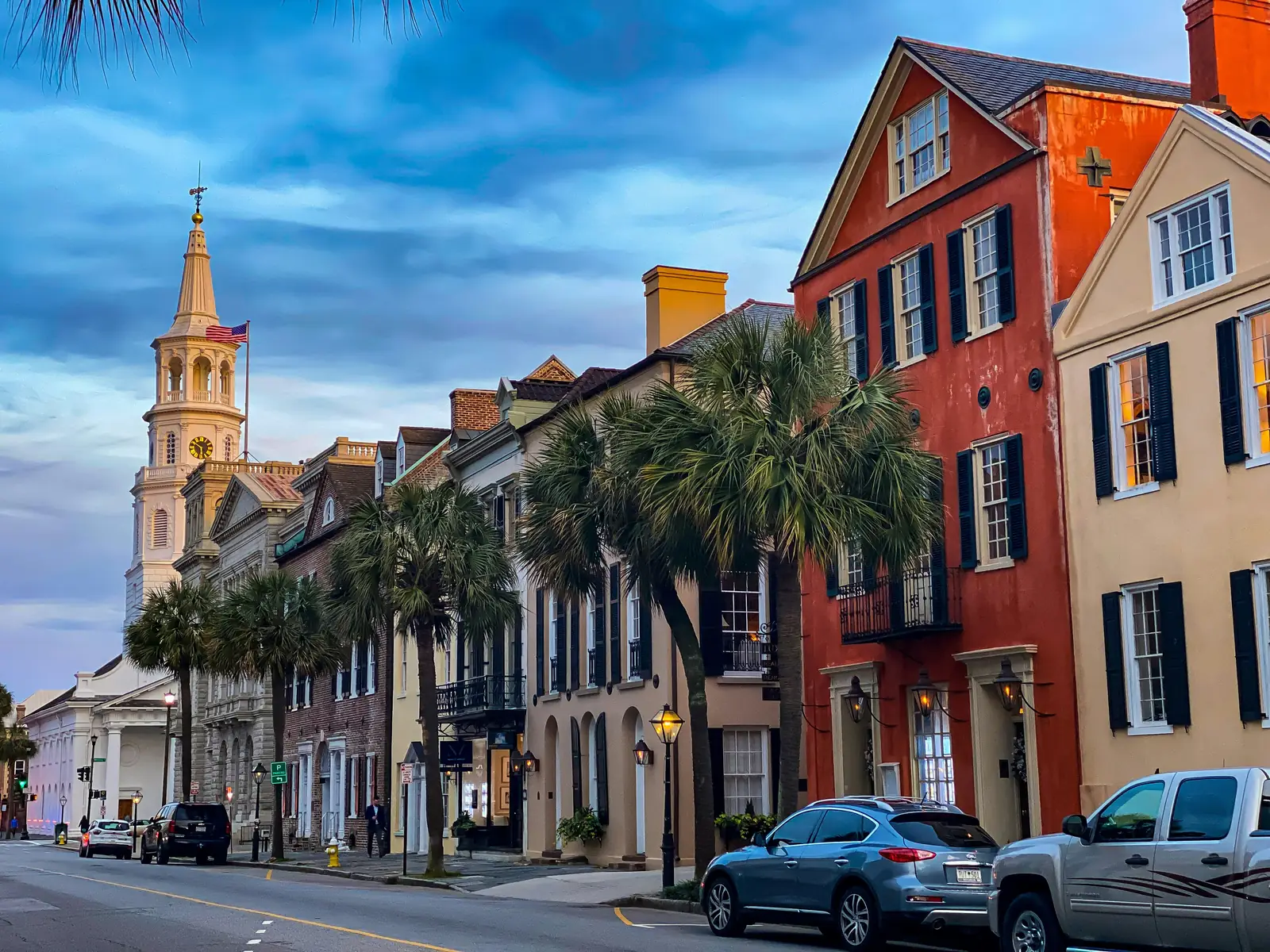 A downtown Charleston shopping street with a white church steeple behind it