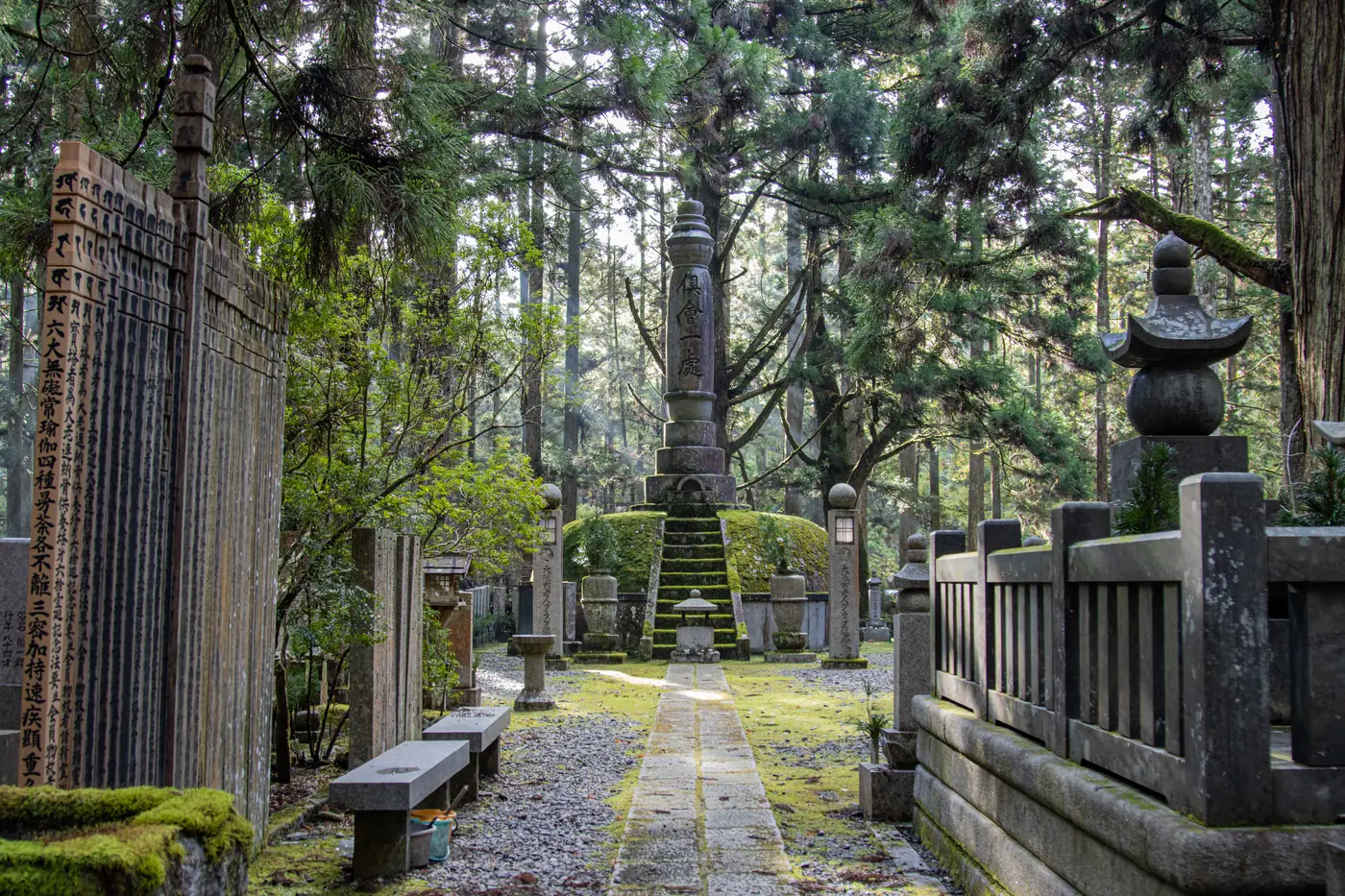 Stone monuments lining the mossy path through Okunoin cemetery on Koyasan