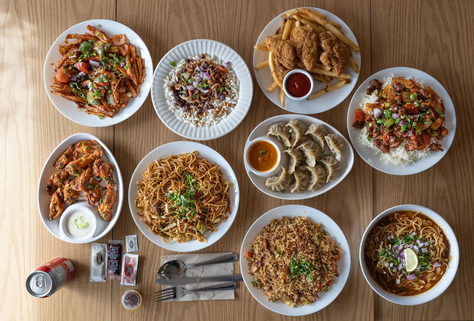 A shared table of noodles, dumplings, fried rice and other dishes