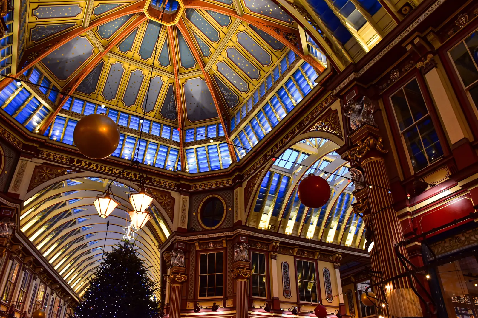 The painted Victorian roof and Christmas tree inside Leadenhall Market