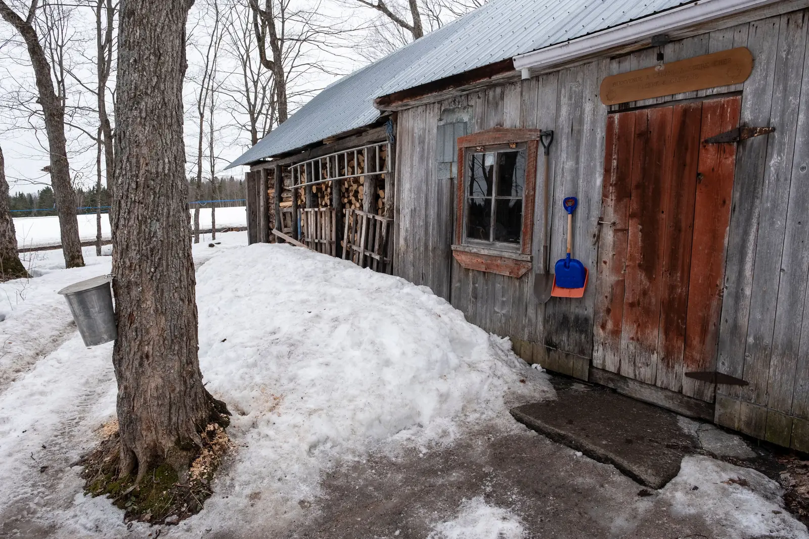 A wooden sugar shack in the snow in Canada