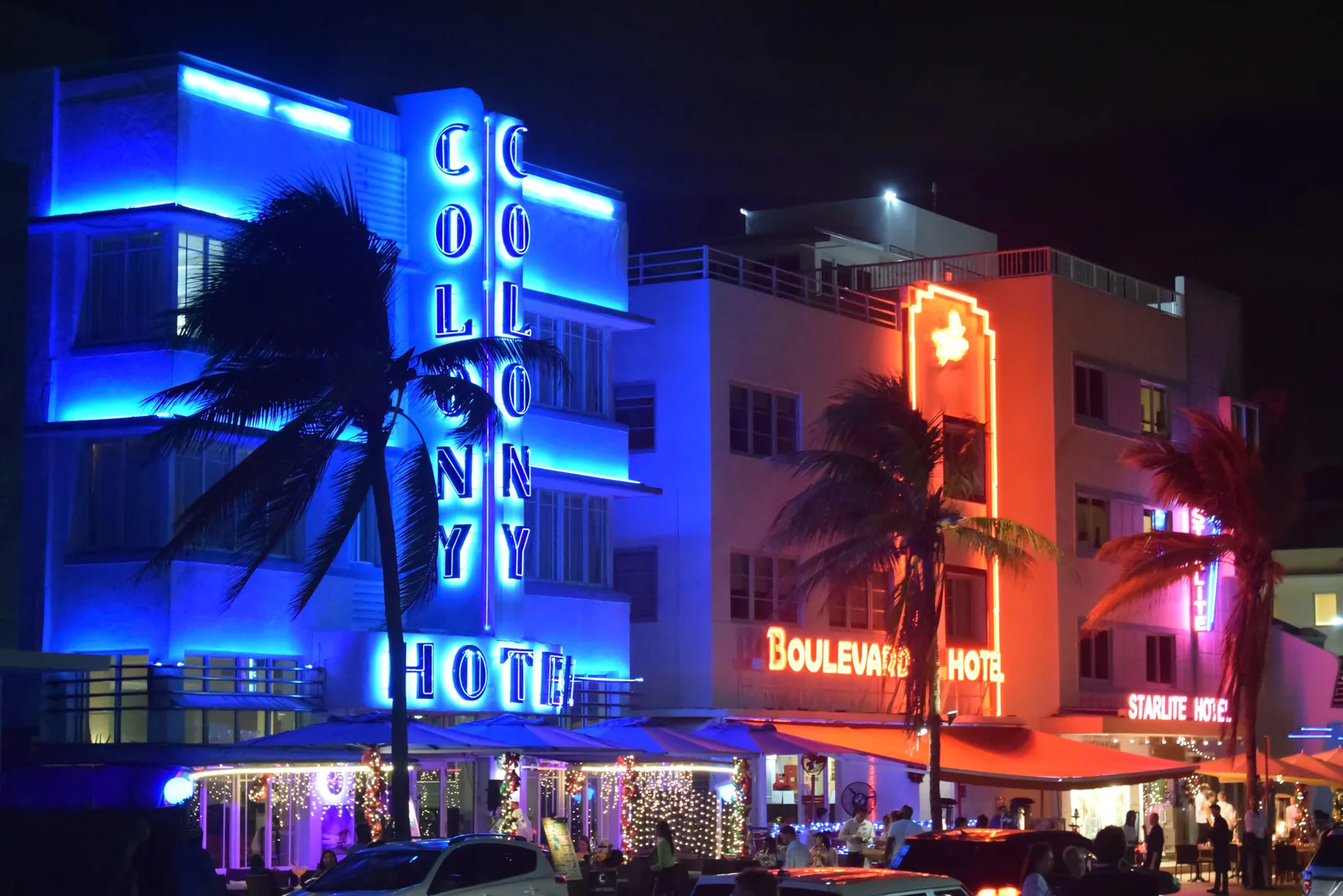 Art deco hotels lit up in neon along Ocean Drive in Miami Beach at night