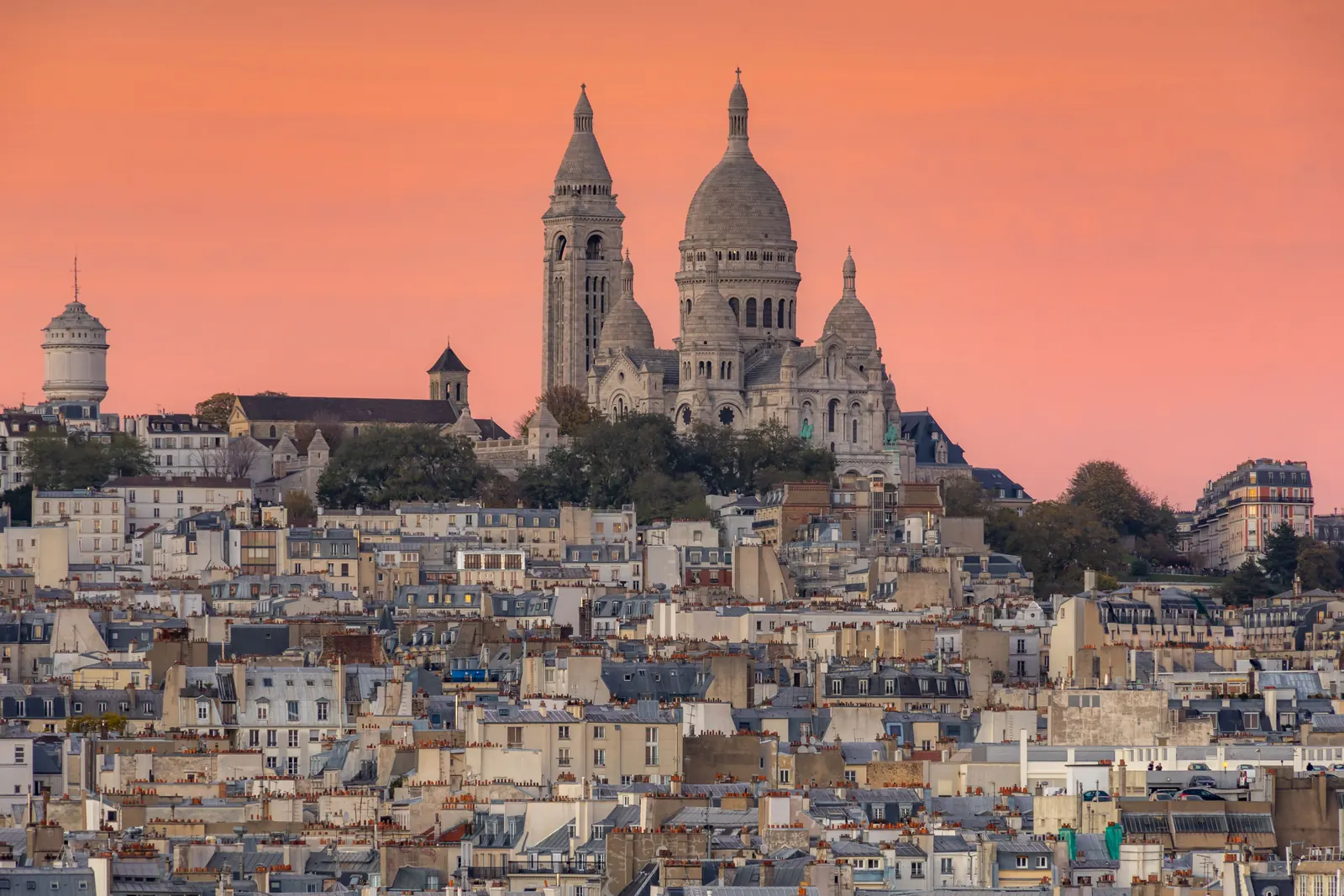 The Sacre Coeur above the rooftops of Montmartre at dusk