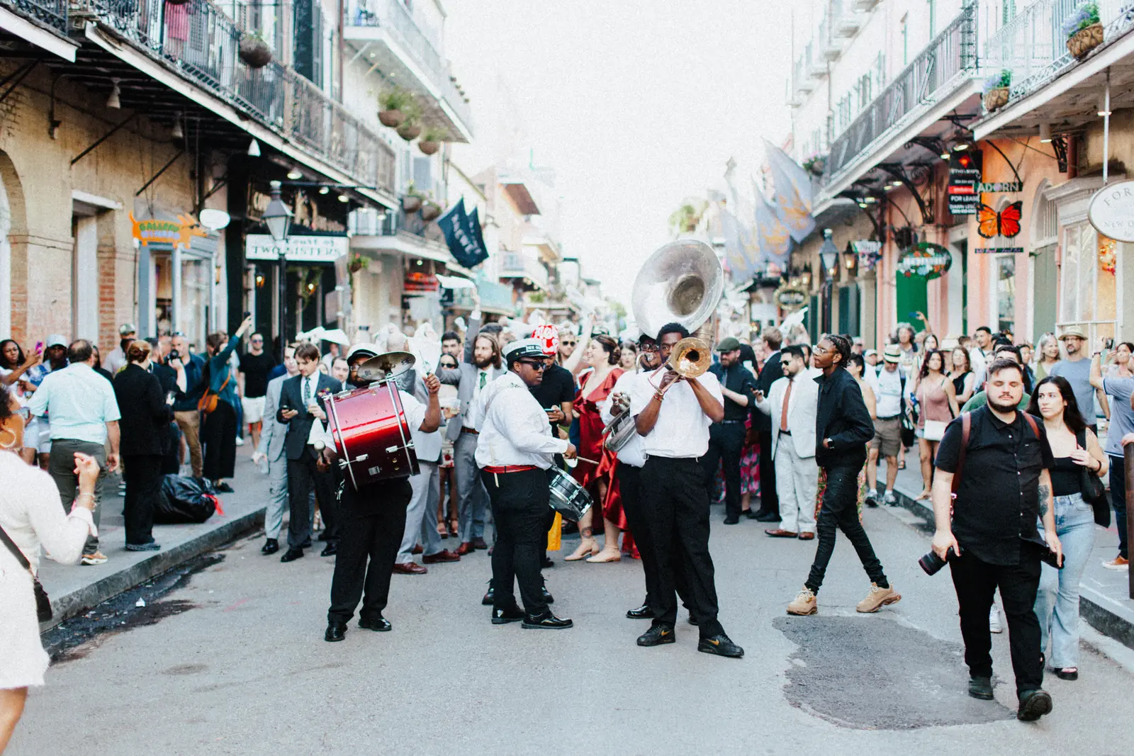 A brass band playing to a crowd on a street in the French Quarter of New Orleans