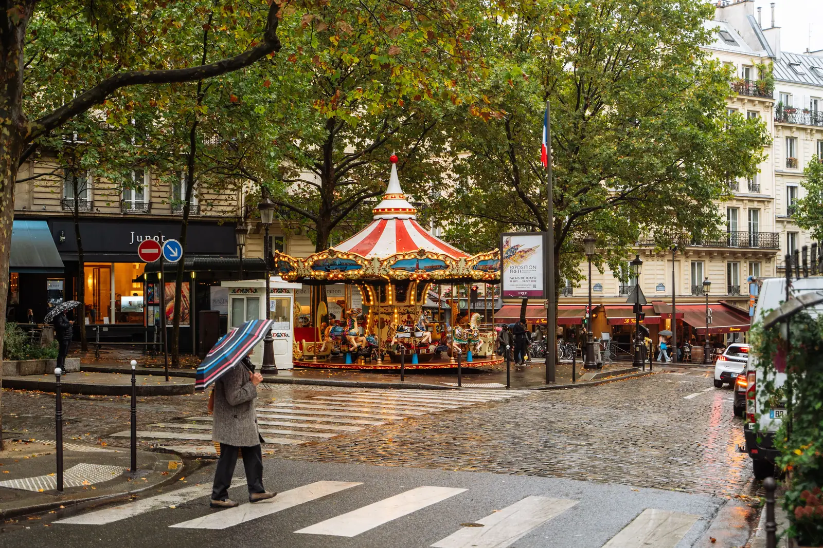 A carousel and wet cobblestones on a rainy autumn day in Paris