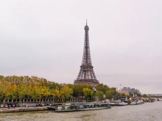 The Eiffel Tower seen through orange autumn leaves along the Seine in Paris