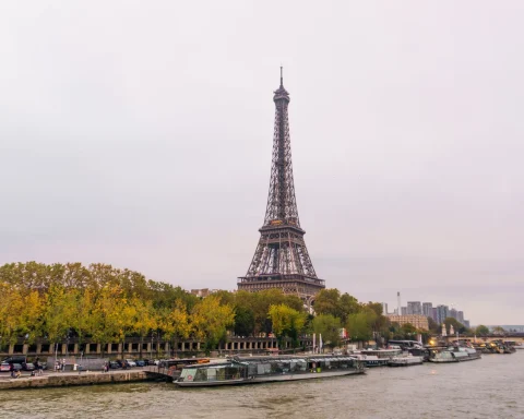 The Eiffel Tower seen through orange autumn leaves along the Seine in Paris