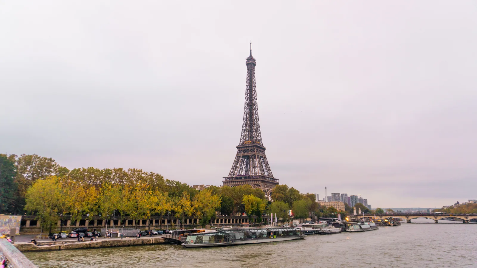 The Eiffel Tower seen through orange autumn leaves along the Seine in Paris