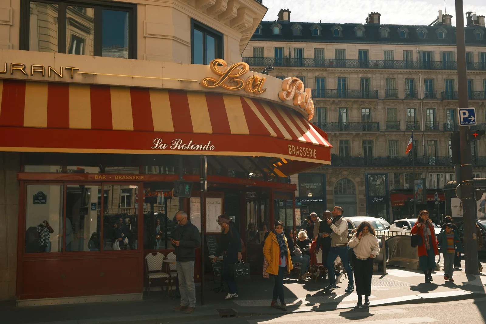 People passing the La Rotonde brasserie on a Paris street