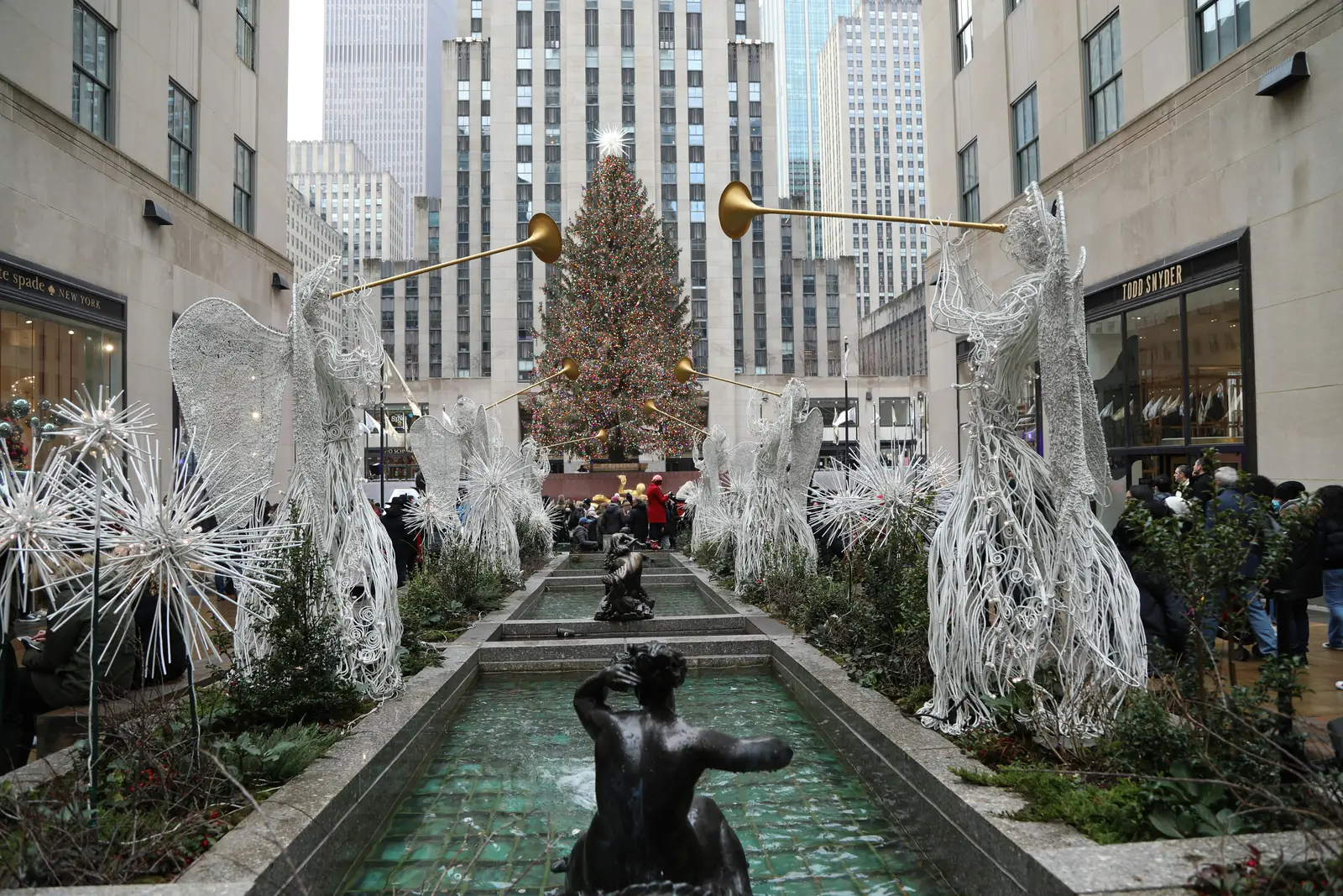 Lit angel figures in the Channel Gardens leading toward the Rockefeller Center tree