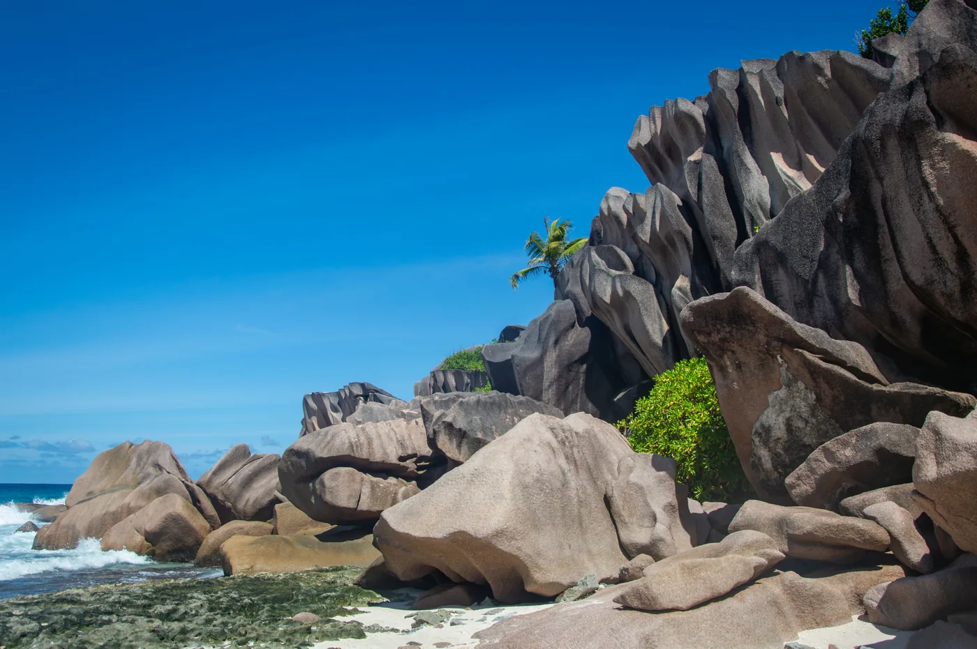 Smooth granite boulders on a beach on La Digue in the Seychelles