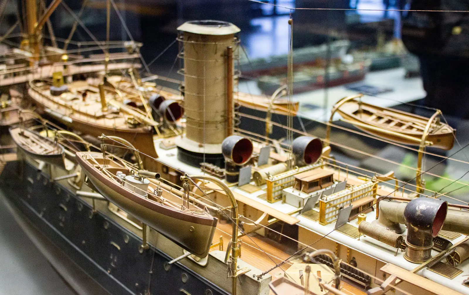 A detailed model ship on display in a museum case