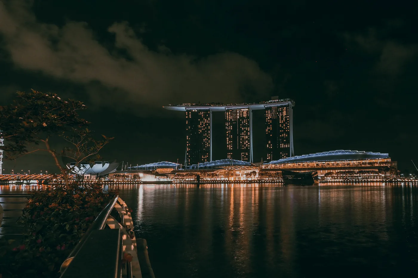 Marina Bay Sands lit up over the water in Singapore at night