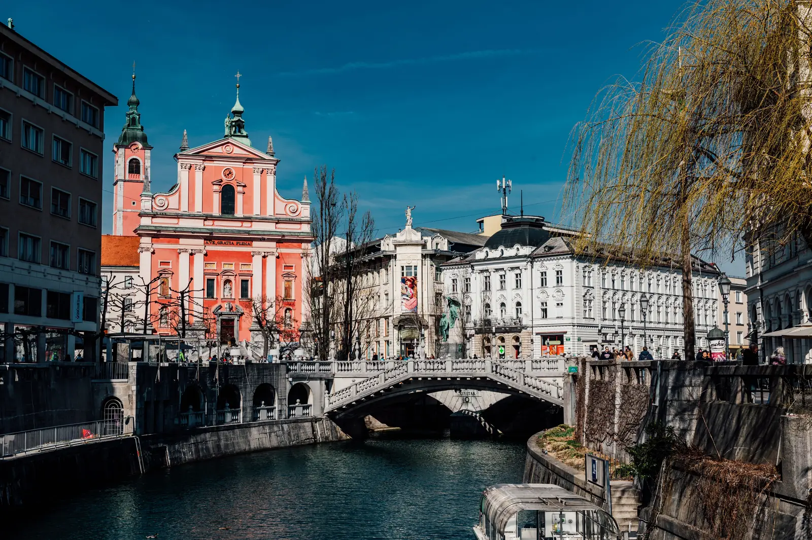 The Triple Bridge and pink Franciscan Church on the river in Ljubljana