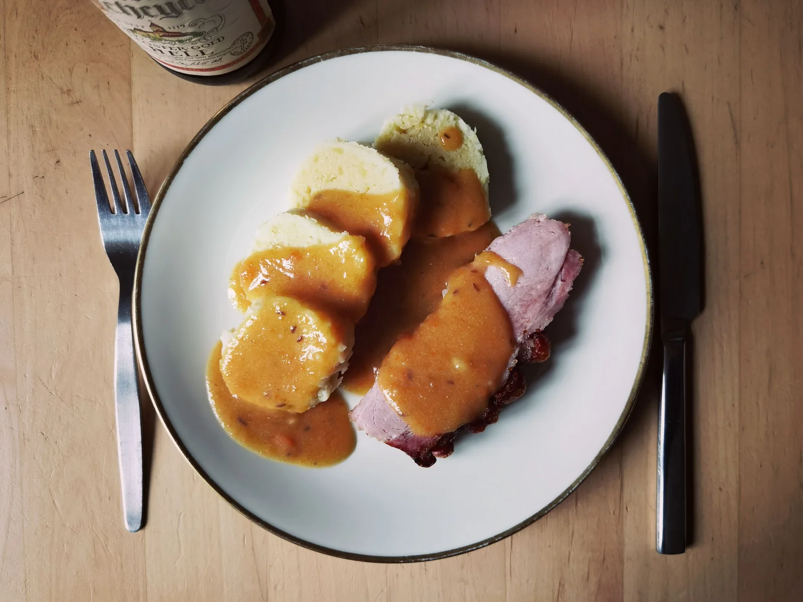 A traditional Czech plate of sliced dumplings, meat and sauce