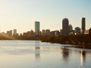 The Boston skyline at sunset seen across the Charles River