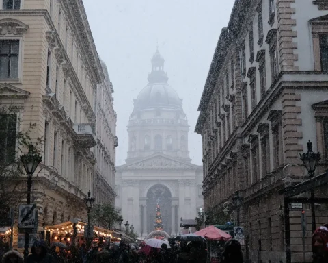Snow falling over a Budapest street with the Christmas market and St. Stephen's Basilica ahead