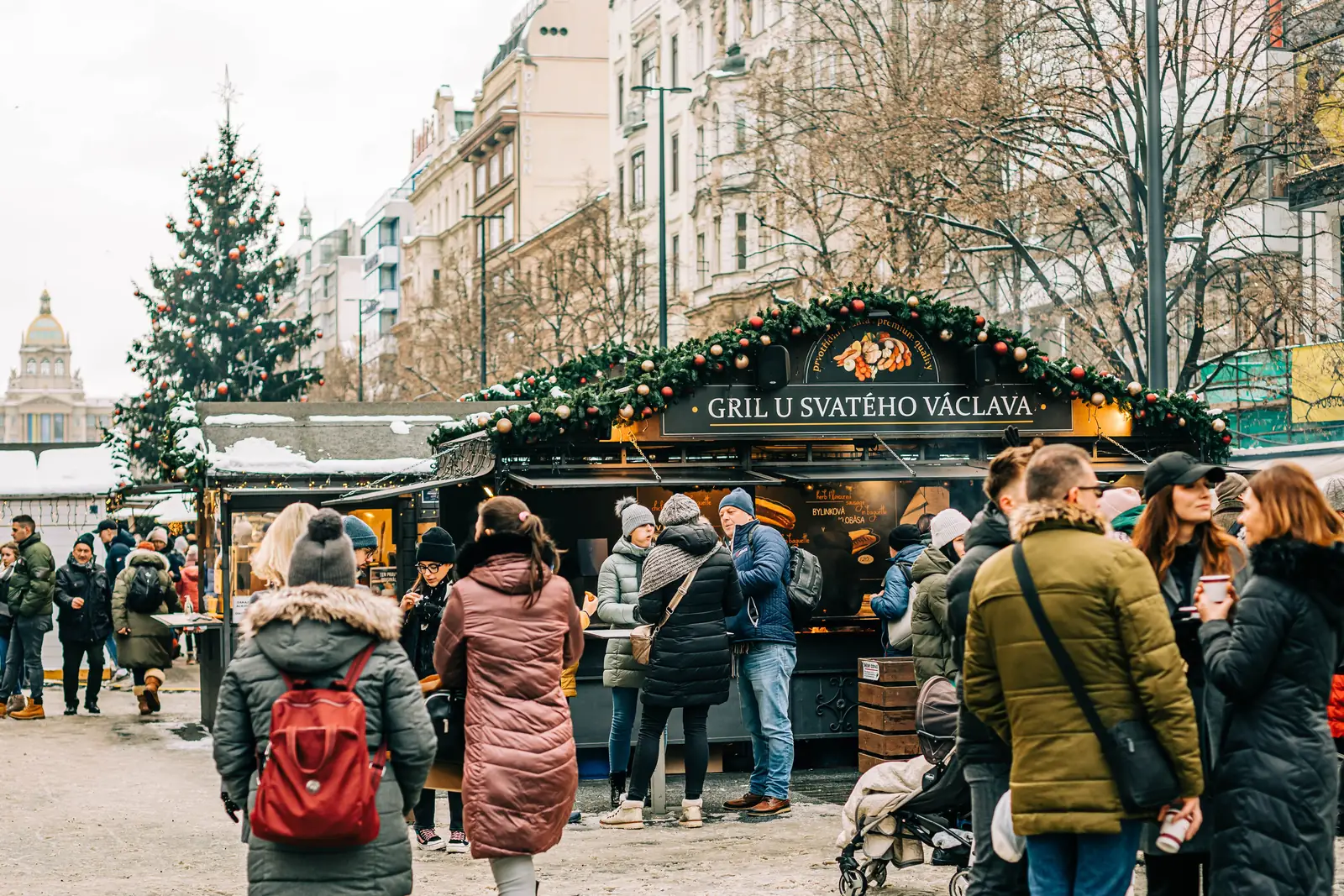 A crowd around a grill stall at the Wenceslas Square Christmas market