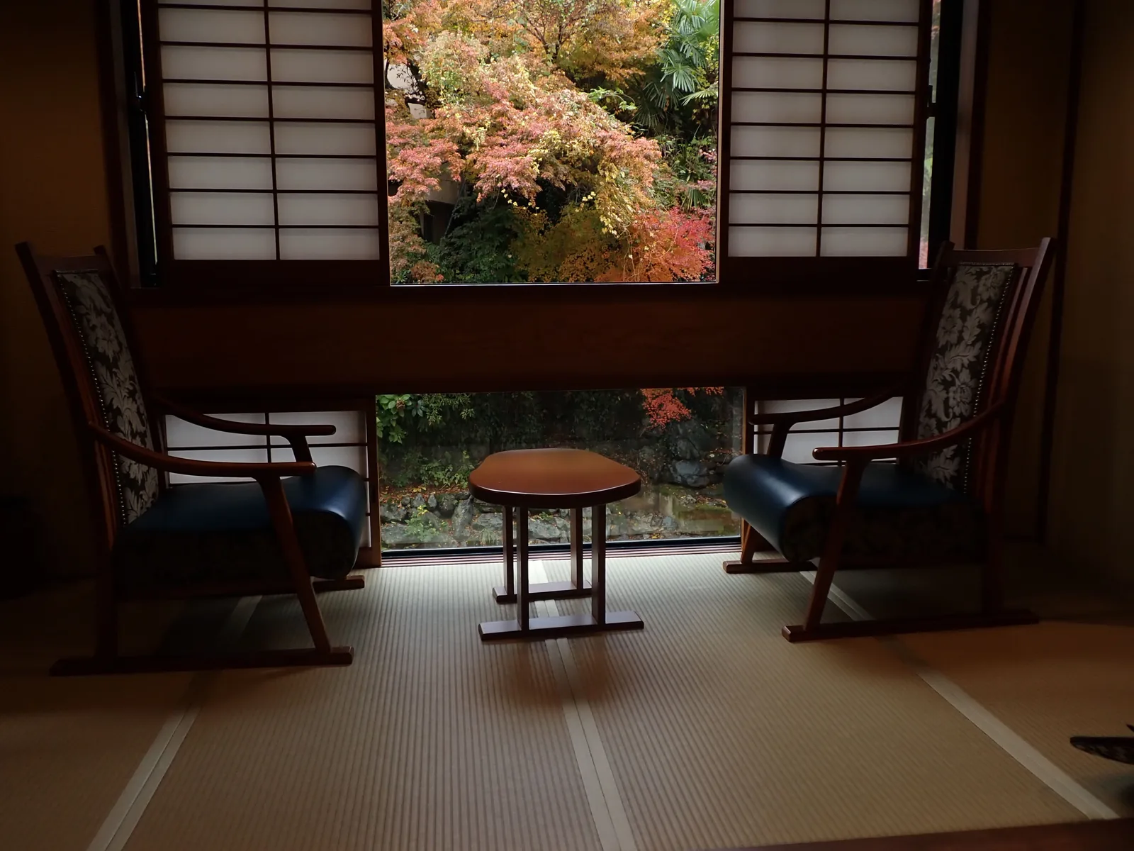 A tatami room in a traditional Japanese inn looking out onto a garden