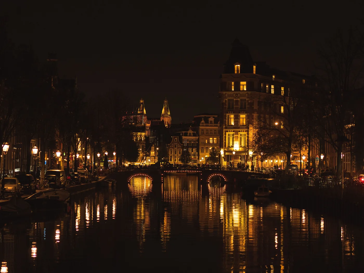An Amsterdam canal lit up at night