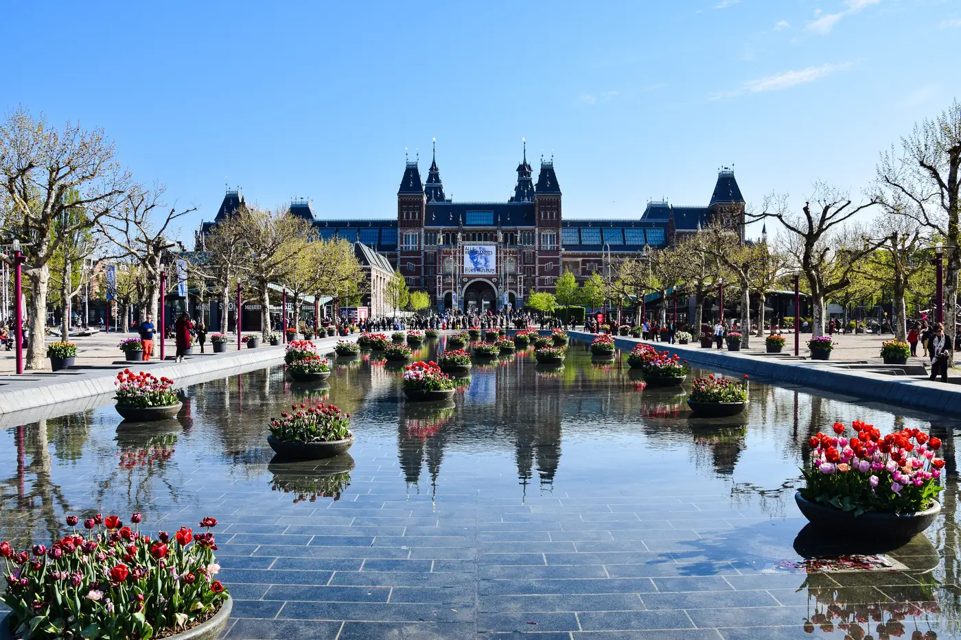 The Rijksmuseum in Amsterdam behind a pond planted with tulips