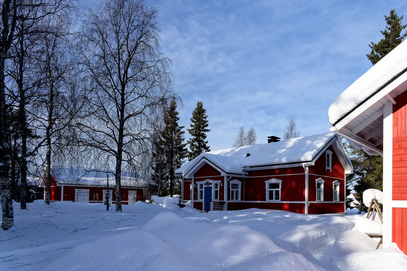 Red wooden houses in the snowy village of Äkäslompolo in Finnish Lapland
