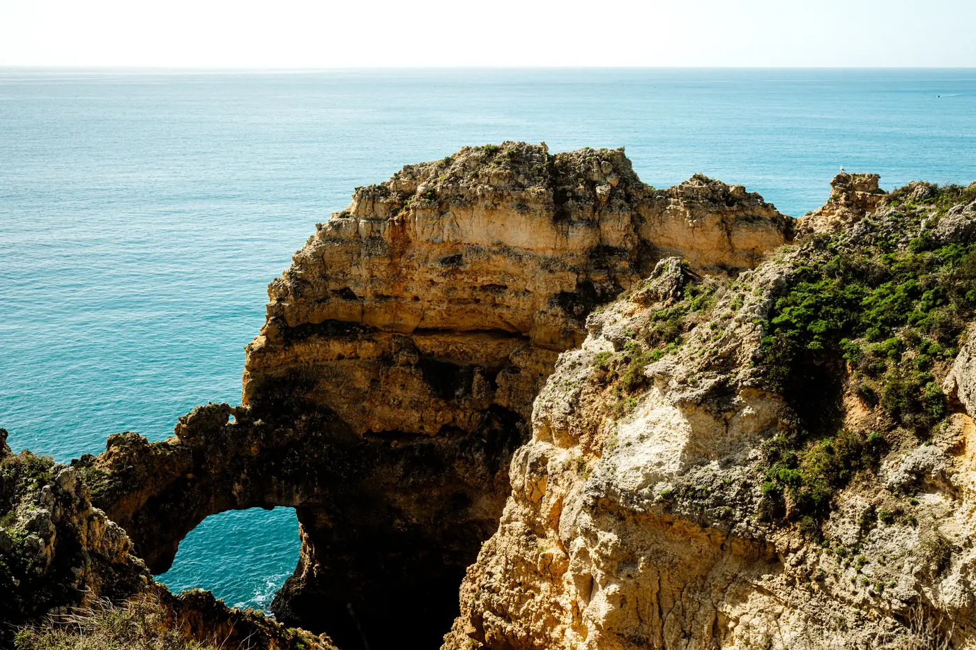 Gold cliffs above a small beach on the Algarve coast in Portugal