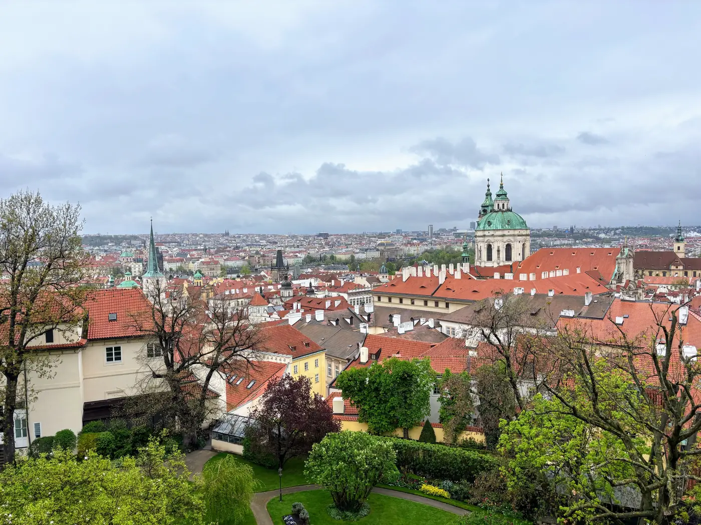 Prague's historic skyline with spring trees in bloom