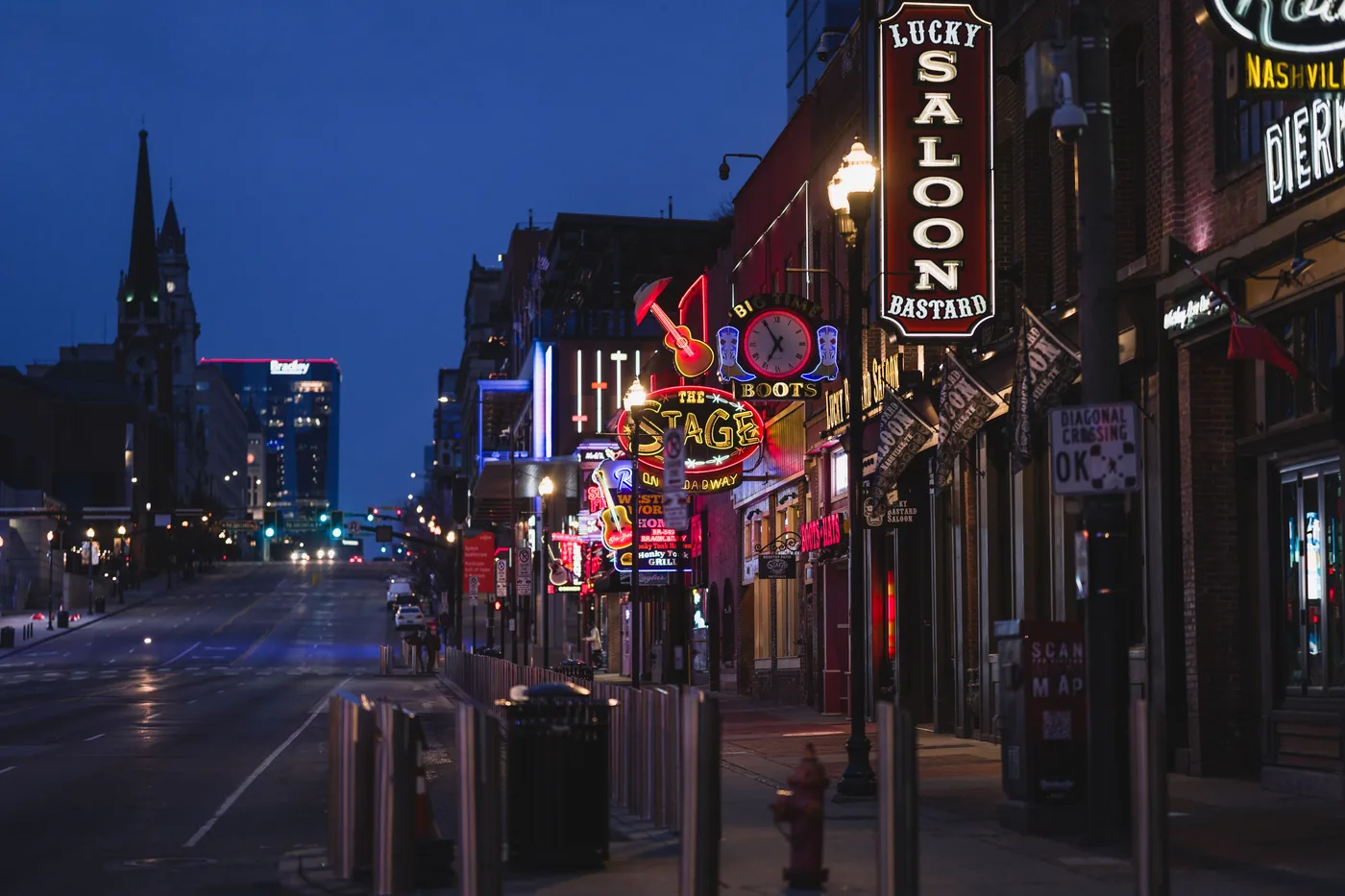 Neon signs and crowds on Broadway in downtown Nashville at night