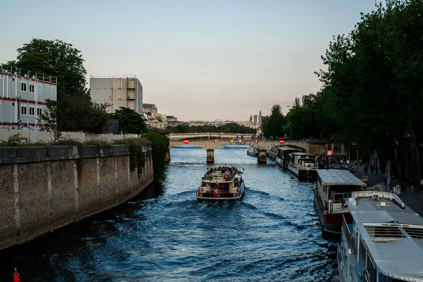 A river cruise boat on the Seine in Paris at dusk