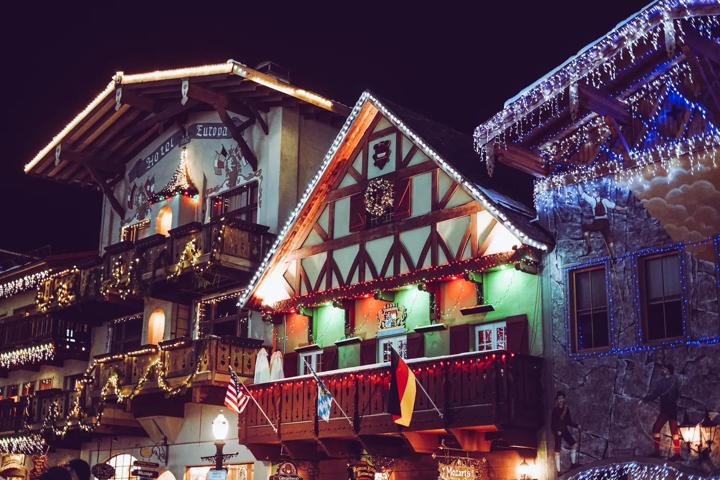 A Bavarian style building in Leavenworth covered in Christmas lights at night