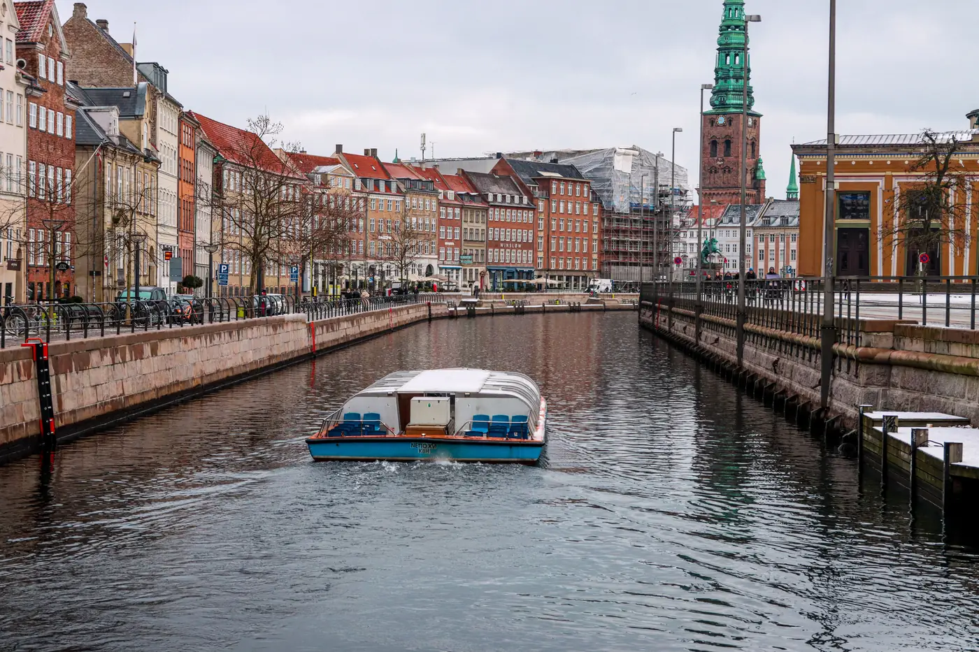 A canal tour boat on a Copenhagen canal in winter
