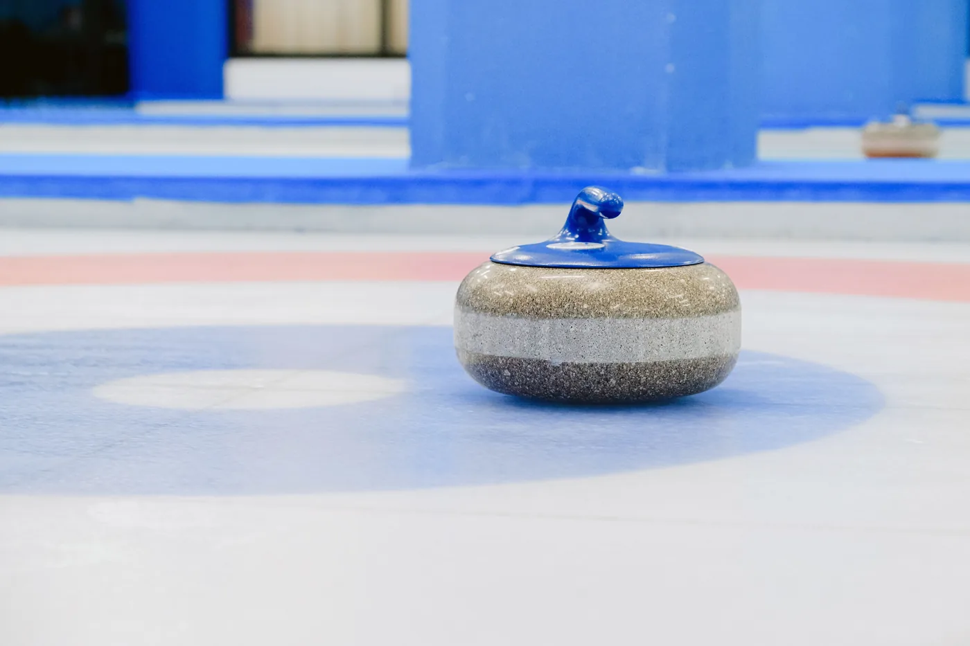 A curling stone sliding across the ice