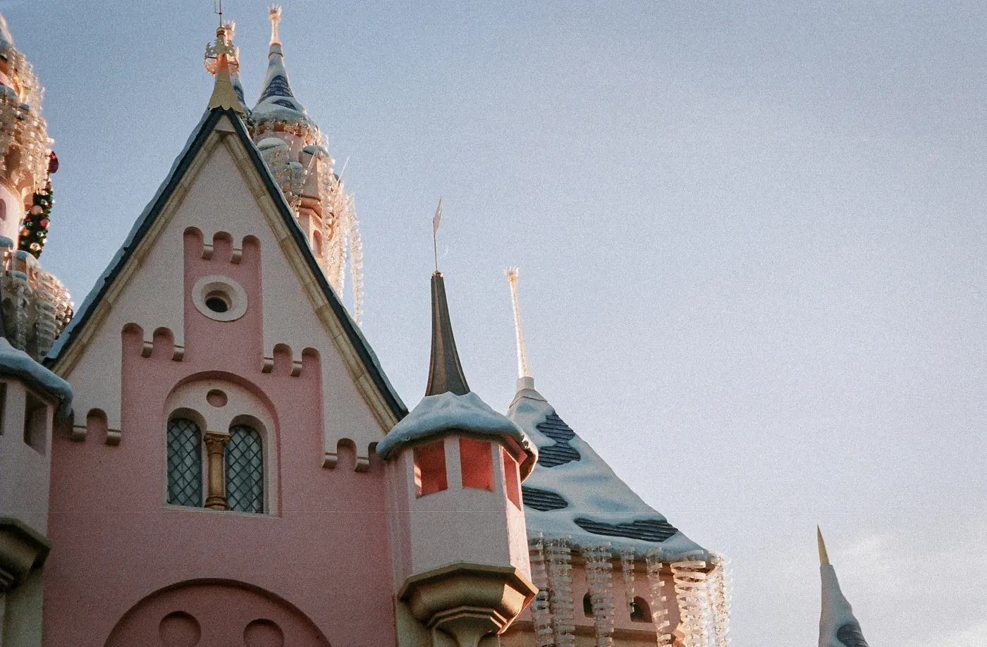 Snow covered turrets on Sleeping Beauty Castle at Disneyland during the holiday season