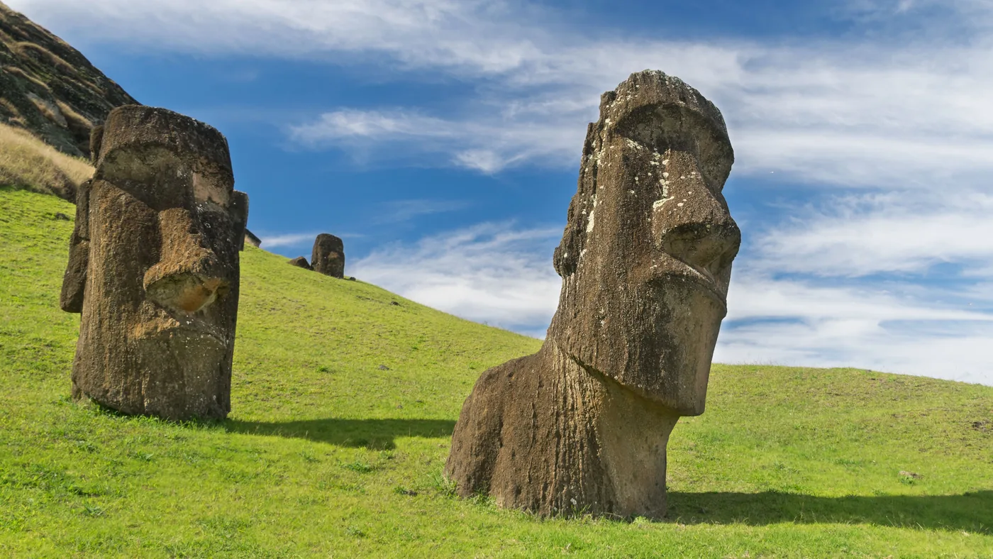 Moai statues on a grassy hillside on Easter Island