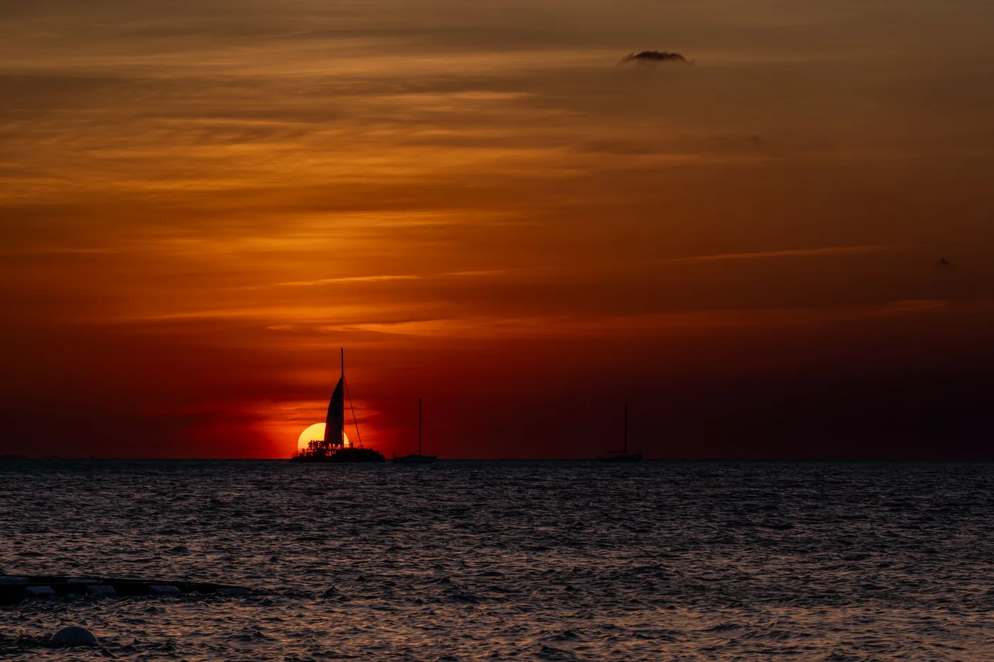 A sailboat silhouetted against the sunset off Key West
