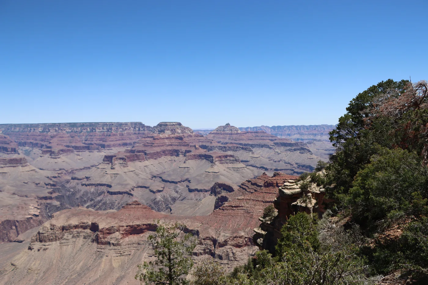Layered red rock walls dropping away into the Grand Canyon in Arizona