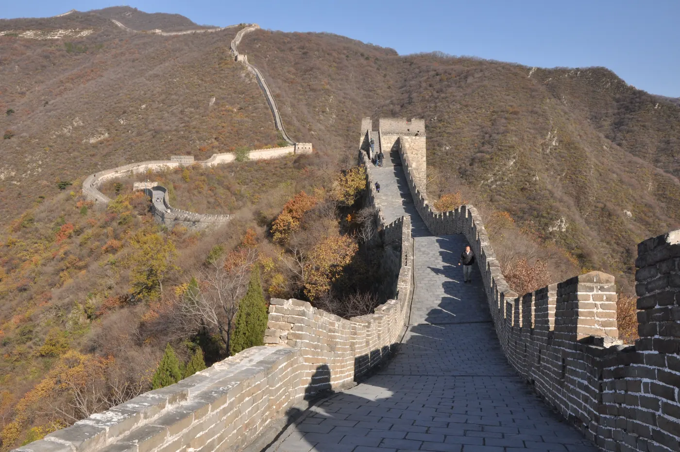 The Great Wall of China winding over hills in autumn
