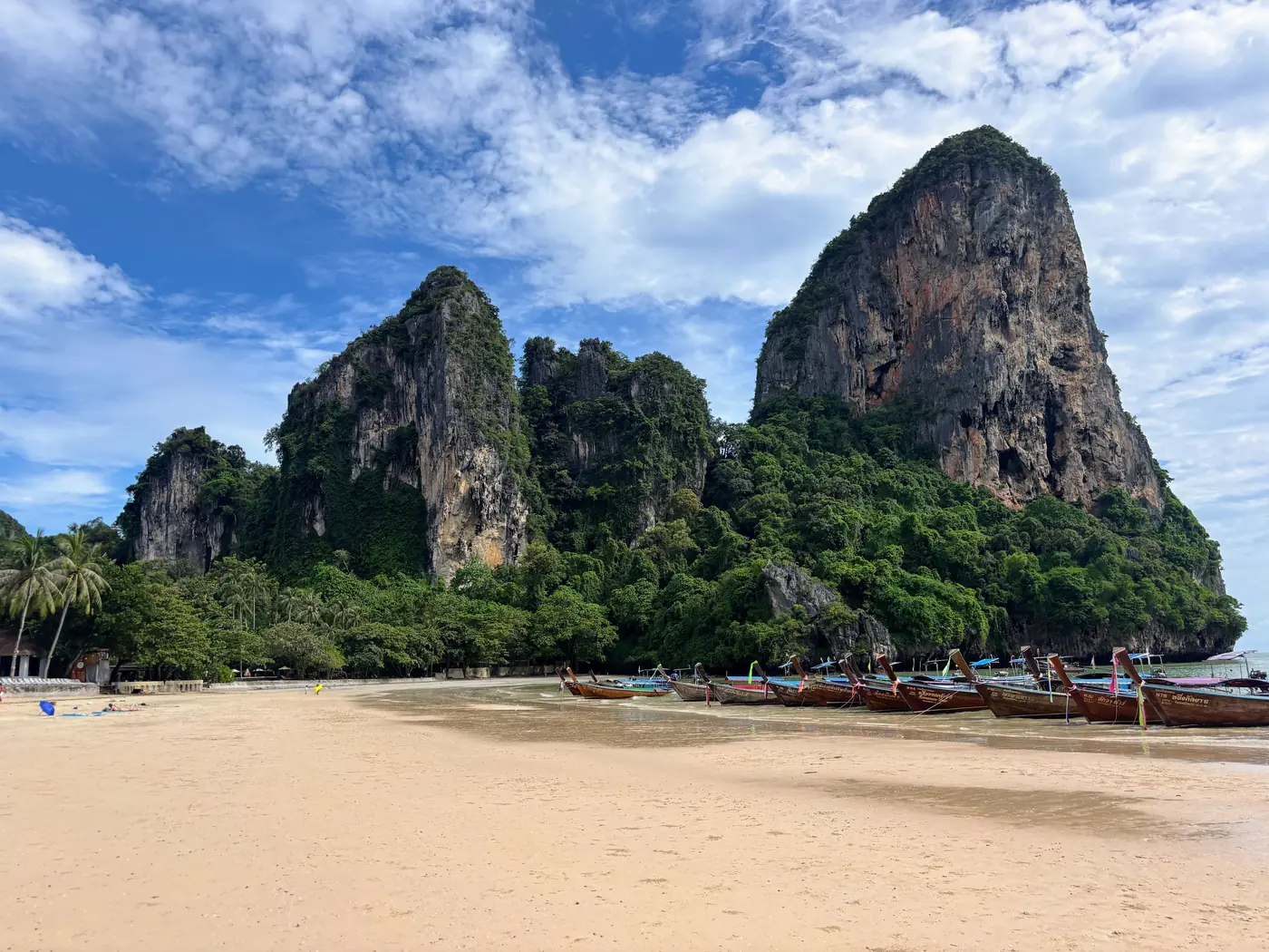 Limestone cliffs and longtail boats on Railay Beach in Krabi, Thailand