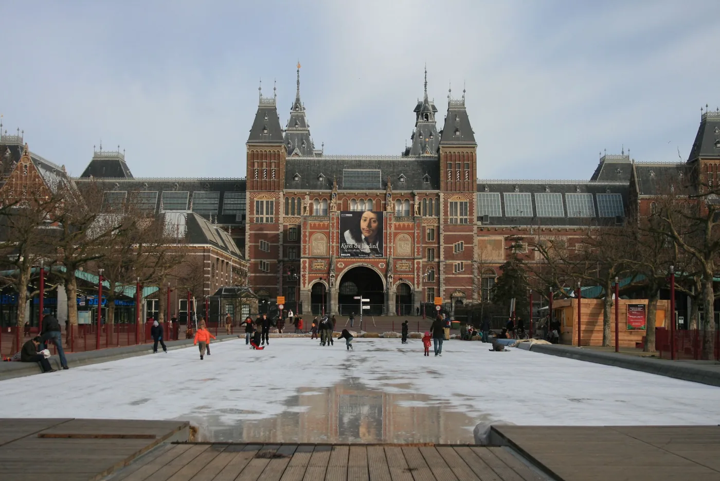 Skaters on the outdoor ice rink at Museumplein in front of the Rijksmuseum