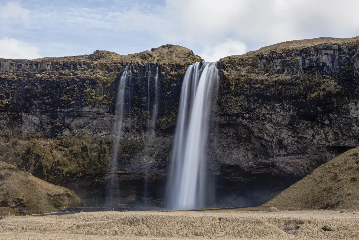 Seljalandsfoss waterfall falling over a green cliff in Iceland