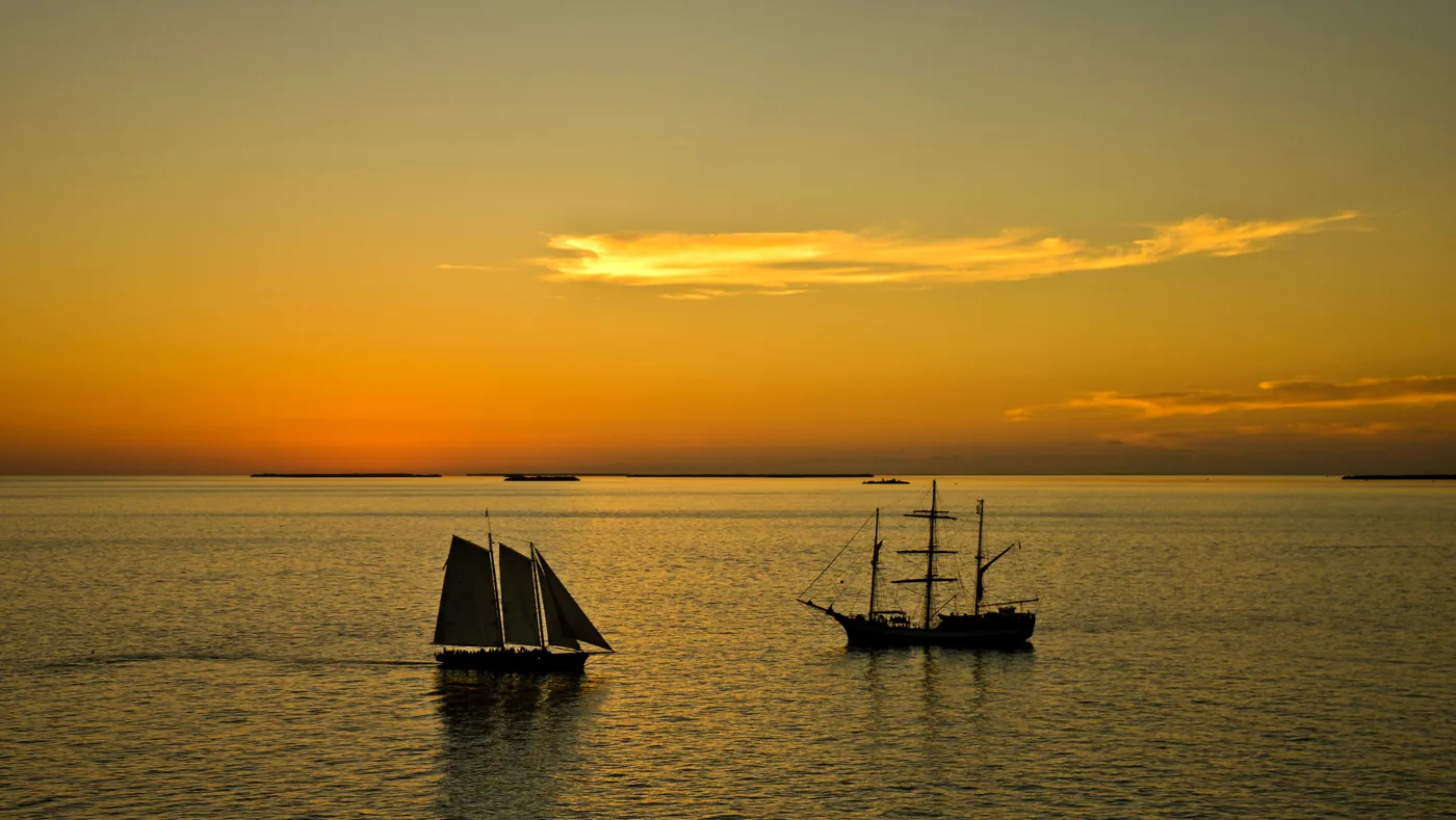 Sailing ships silhouetted against the sunset off Key West