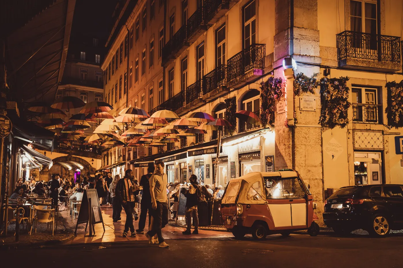 Restaurants and bars lit up at night in Lisbon's historic center
