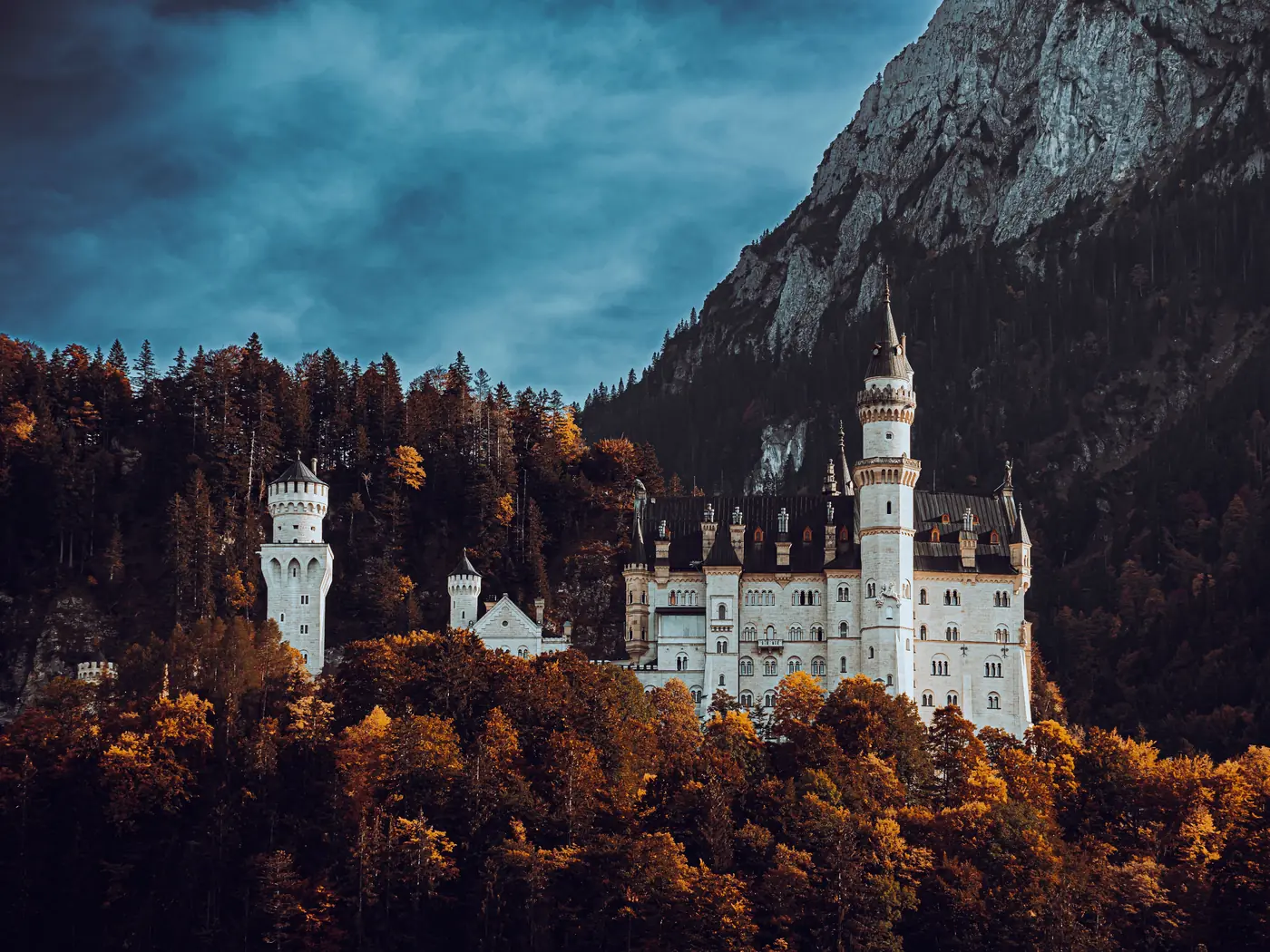 Neuschwanstein Castle above autumn forest in Bavaria