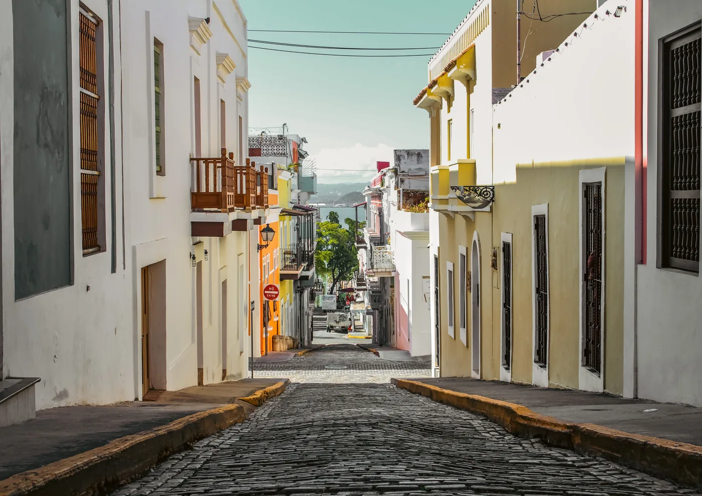Blue cobblestones and colorful buildings on a street in Old San Juan