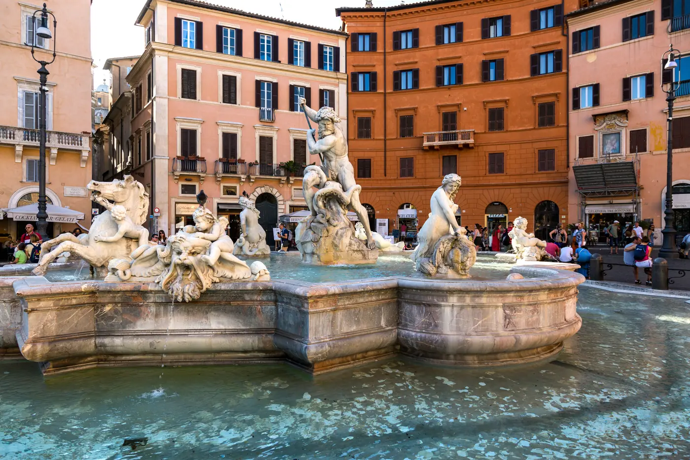 The Neptune fountain and the ochre buildings of Piazza Navona in Rome