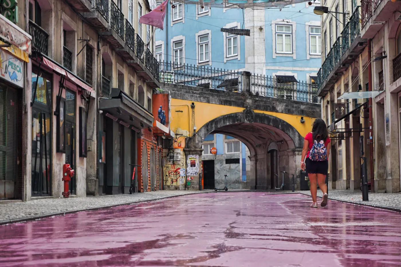 A walker on Pink Street in Cais do Sodré, Lisbon